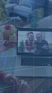 Animation of database over caucasian couple wearing santa hats talking with friends over video call