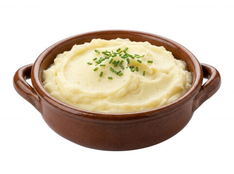 Small bowl of mashed potatoes garnished with fresh chives isolated