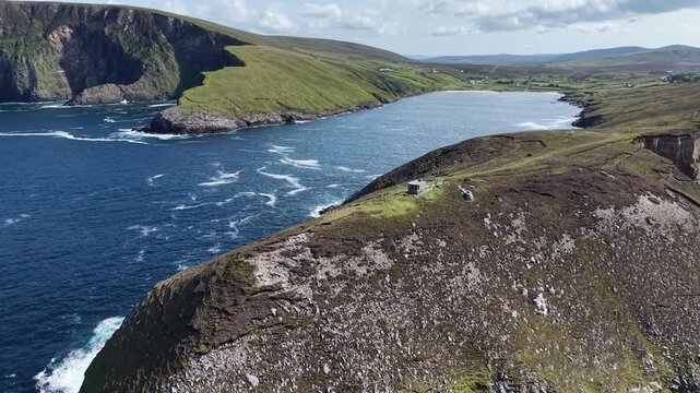 Coastal landscape no visible action static scene, in ocean and cliffs, with cliffs, ocean, from a aerial view perspective, with blue, green accents, and serene natural beauty mood.