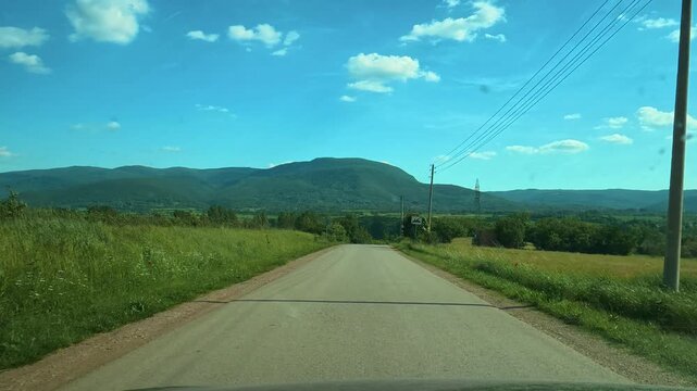 Clear blue sky above rolling green hills. Balkans, Serbia