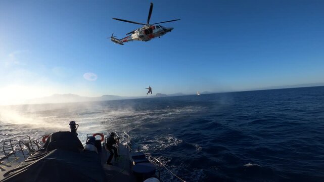 Helicopter of the Spanish Rescue training with a customs patrol boat in Alicante coast, Spain. 