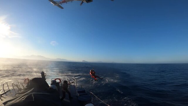 Helicopter of the Spanish Rescue training with a customs patrol boat in Alicante coast, Spain. 