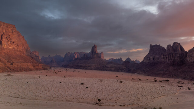 High Angle Wide Panoramic Landscape View of Sandstone Canyon Mountains and Desert Valley Under Dramatic Stormy Sunset Sky in Wadi Al Disah, Tabuk, Saudi Arabia