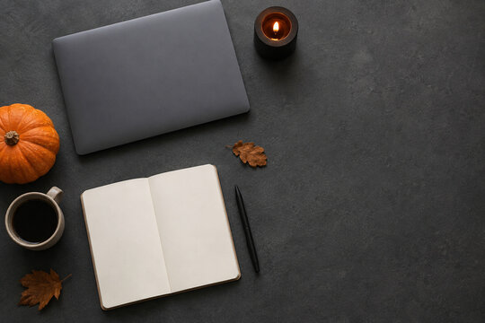 Modern Halloween workspace flat lay with pumpkin and coffee