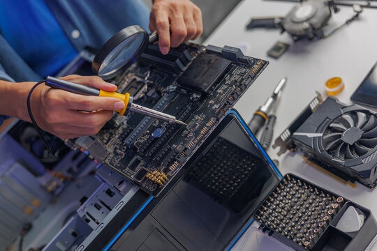 A computer technician repairing or assembling a desktop computer.