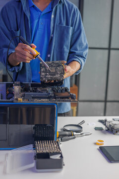 A computer technician repairing or assembling a desktop computer.