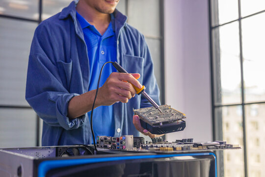 A computer technician repairing or assembling a desktop computer.