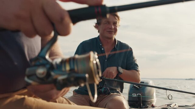 Two friends fishing on the lake from the boat