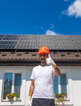 Installing solar panels on a house roof. Selective focus.