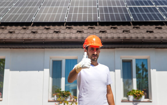 Installing solar panels on a house roof. Selective focus.