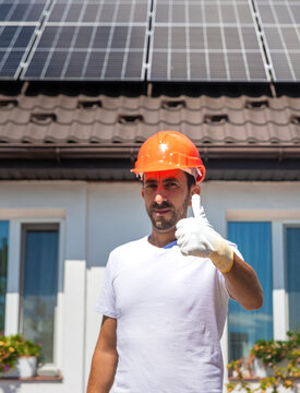 Installing solar panels on a house roof. Selective focus.