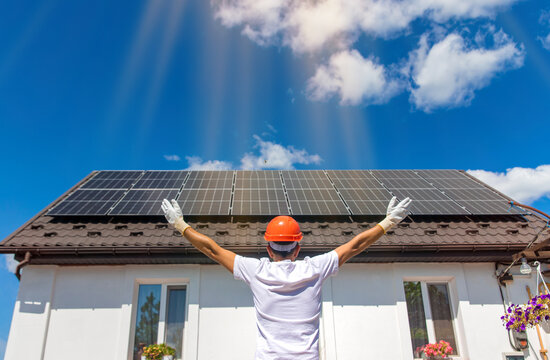 Installing solar panels on a house roof. Selective focus.