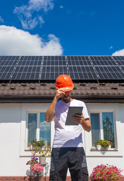Installing solar panels on a house roof. Selective focus.