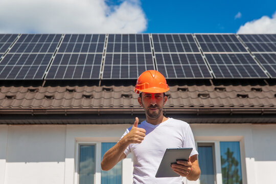 Installing solar panels on a house roof. Selective focus.