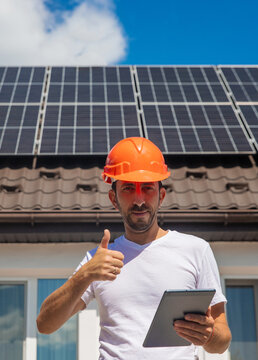 Installing solar panels on a house roof. Selective focus.
