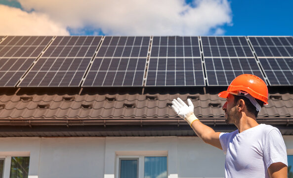 Installing solar panels on a house roof. Selective focus.