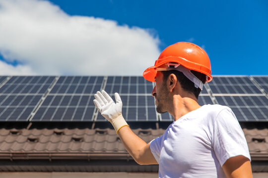 Installing solar panels on a house roof. Selective focus.