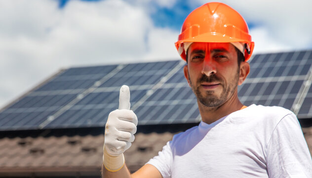 Installing solar panels on a house roof. Selective focus.