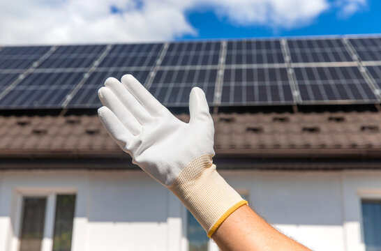 Installing solar panels on a house roof. Selective focus.
