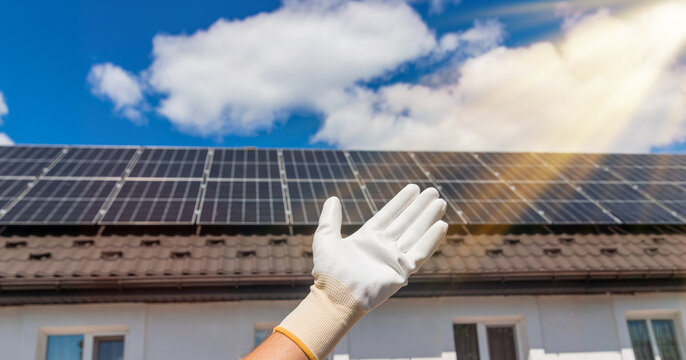 Installing solar panels on a house roof. Selective focus.