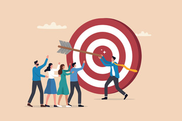 Business team hitting bullseye target with big arrow representing success © Design gallery