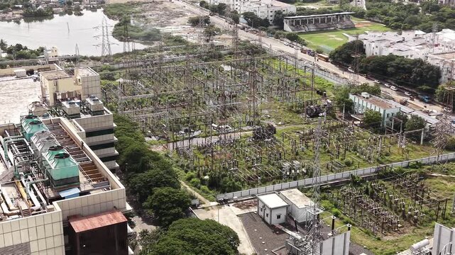 High voltage electrical substation surrounded by green vegetation