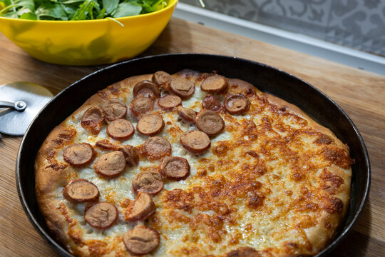 Homemade white pizza with sausage and cooked ham
