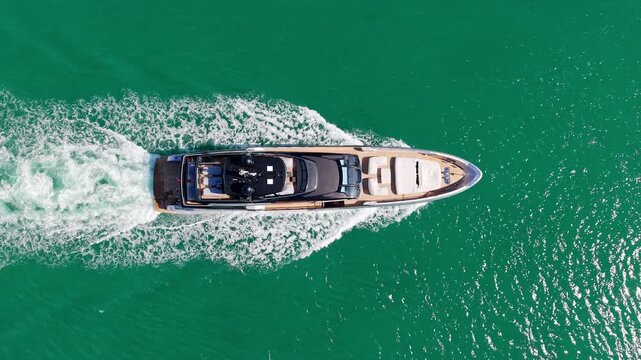 Luxury boat and elegant yacht cruise across turquoise sea from marina. Motorboat follows scenic route. Yacht, boat, sea and luxury complete perfect summer destination and boating journey