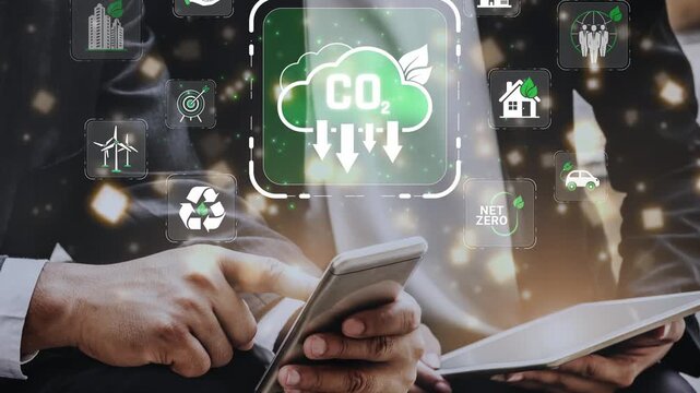 Business professionals discussing sustainability strategies with smartphone and tablet in hands surrounded by eco-friendly icons and CO2 reduction concepts. Sigmoid