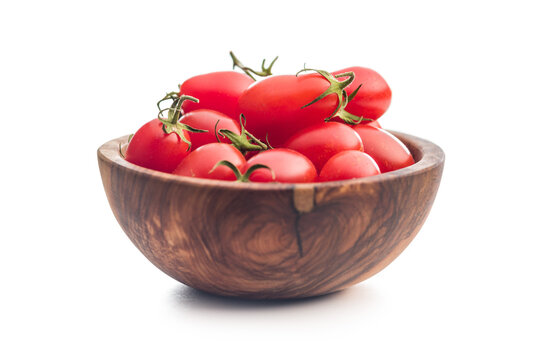 Fresh Cherry Tomatoes in a Rustic Wooden Bowl on White Background . Bright Red Healthy Produce
