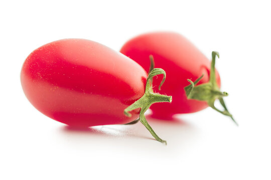 Fresh Red Plum Tomatoes Close-Up On White Background With Green Stems, Healthy Food Concept