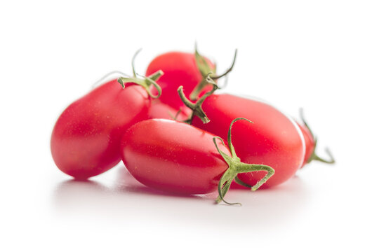 Fresh Red Plum Tomatoes Close-Up On White Background With Green Stems, Healthy Food Concept