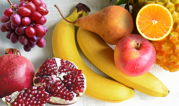 Fresh fruits mixed. Tasty fruits background, citruses, apples, grapes.