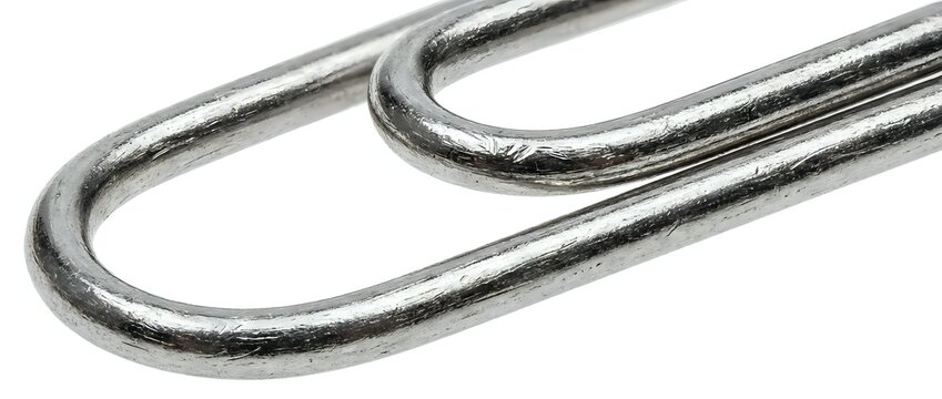 Macro shot of two metal safety pins with worn silver finish on white