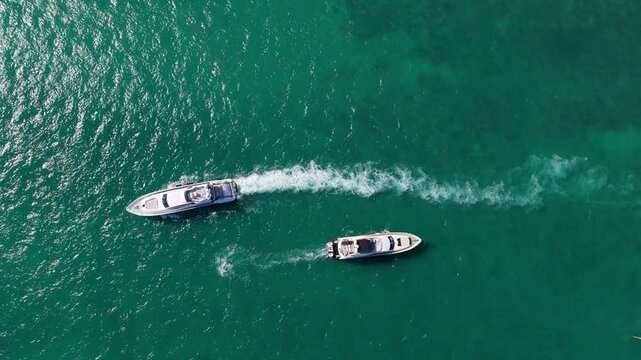 Luxury yacht explores blue sea beyond marina. Boat keeps steady course. Motorboat follows elegant wake. Summer travel creates unforgettable vacation memories
