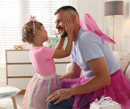 Happy father having fun with his daughter at home