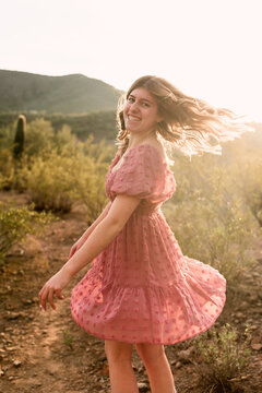 Young Woman Twirling in Desert
