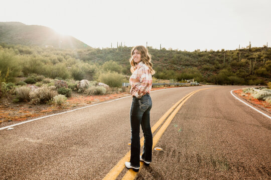 Girl Walking in Desert Road
