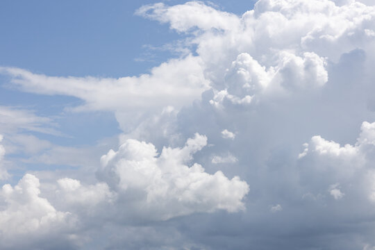 Large white cumulus clouds against blue sky in daylight