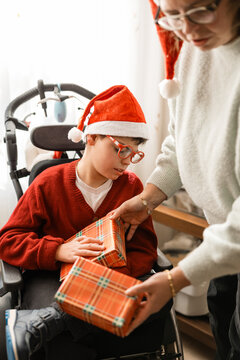 Family celebrating christmas with boy receiving presents