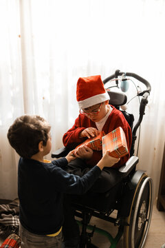 Child with cerebral palsy receiving christmas present