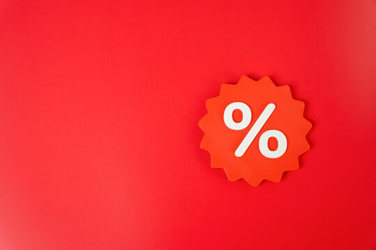Percentage discount sticker on a red background. Sale and discount concept. Price reductions and special offers attract customers and increase purchase demand.