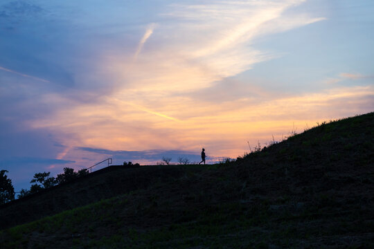 A person on Monks Mound at sunset.