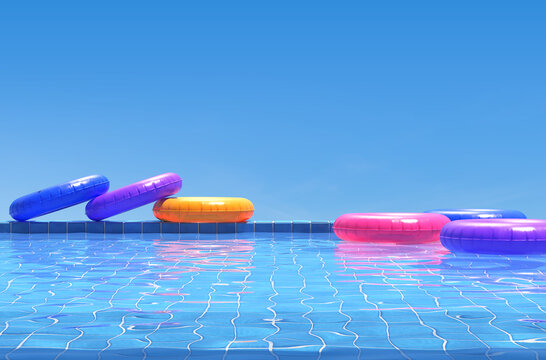Colorful swimming rings in blue swimming pool. Pool party, summer background.  