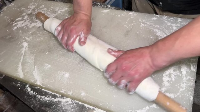 Udon Dough Stretched around a Wooden Rolling Pin: Handmade Japanese Noodles at an Izakaya (Step 4 of 5)