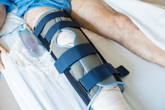Patient recovering from knee surgery wearing a brace