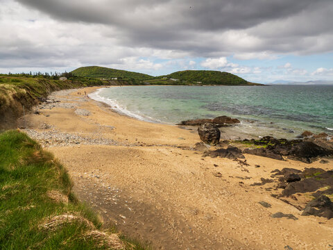 Peaceful cove with gentle waves and moss-covered rocks