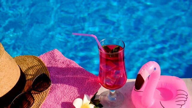 pink cocktail with flamingos on the background of the pool. Selective focus.