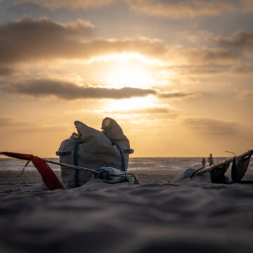 Traditional fishing equipment on beach at sunset in Denmark