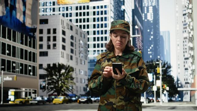 Pouting female soldier looks at smartphone with disappointment while standing on metropolitan city street; Military officer in business center frowns, annoyed by message on mobile phone.